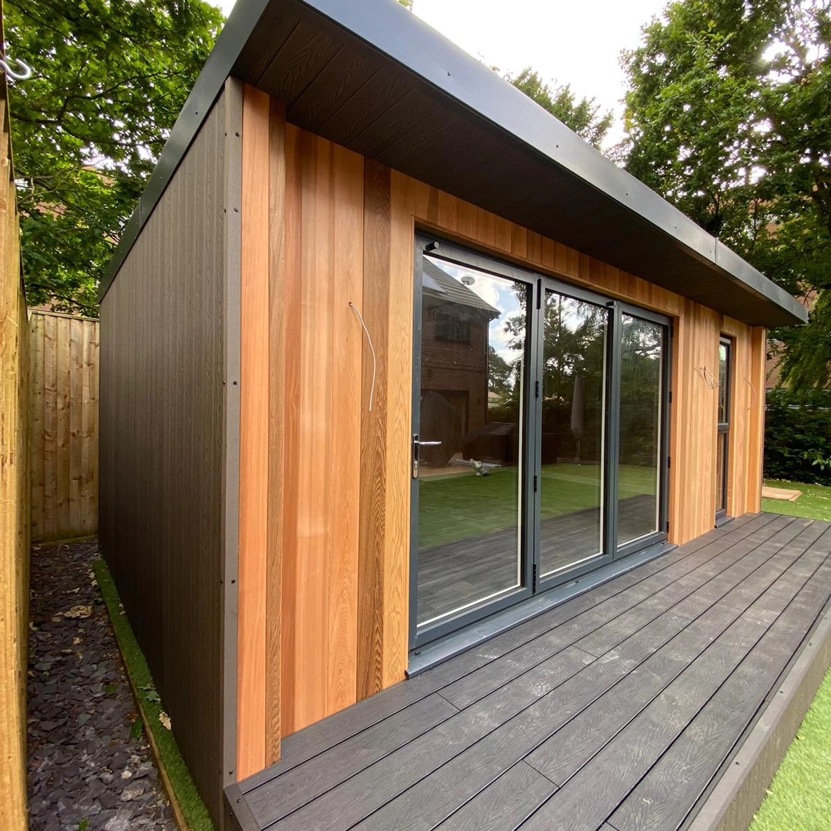 Cedar garden room with full-width aluminium bifold doors