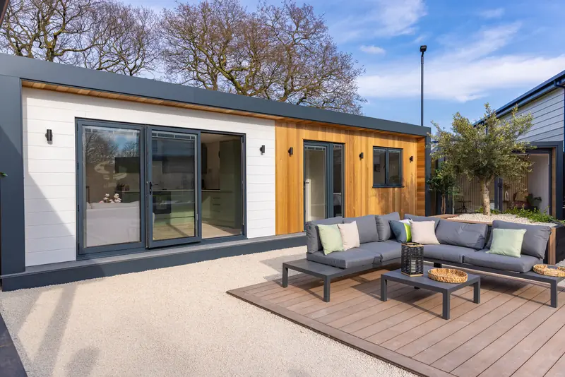 Modern SIP garden annexe style with white render and cedar feature wall — a high-end solution for Surrey residential plots