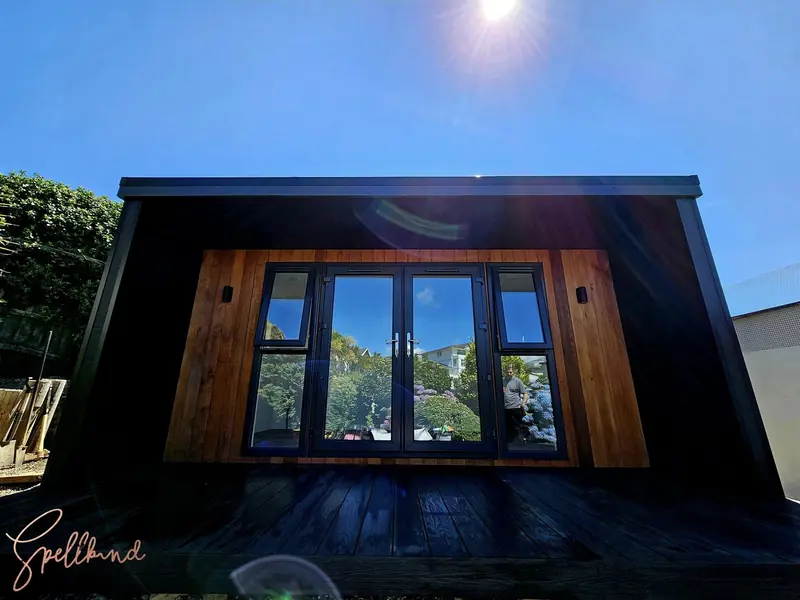 Striking black and cedar garden room style with large glazed doors — maximising light and space for modern Surrey homes
