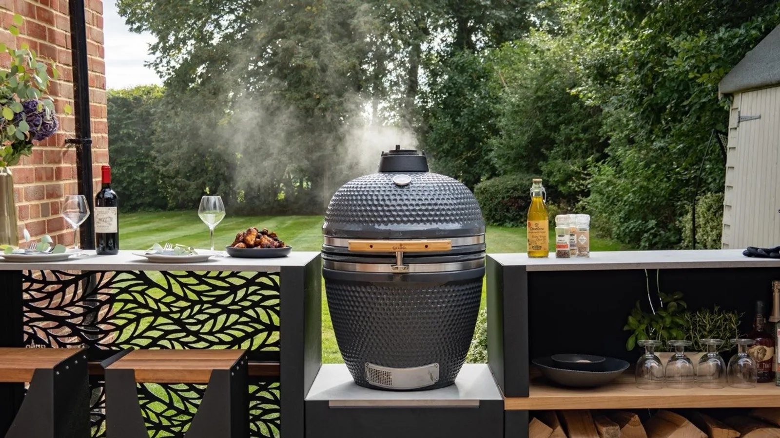 Grillo outdoor kitchen with a ceramic kamado set within a landscaped Surrey garden