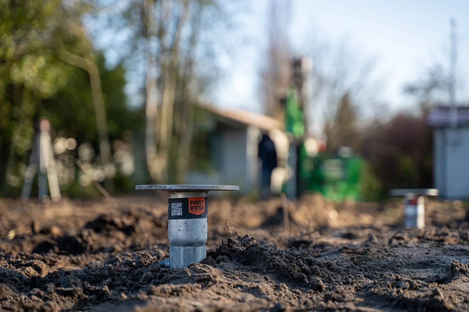 Close-up of a galvanised First Base ground screw head installed at finished level