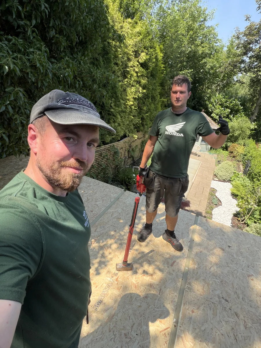 Henry Helps on a SIP garden room base during panel installation in Surrey