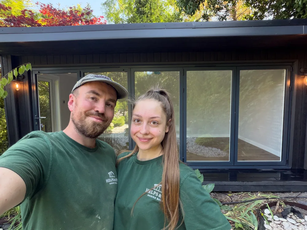 Henry and Lola Helps outside a completed Surrey garden room