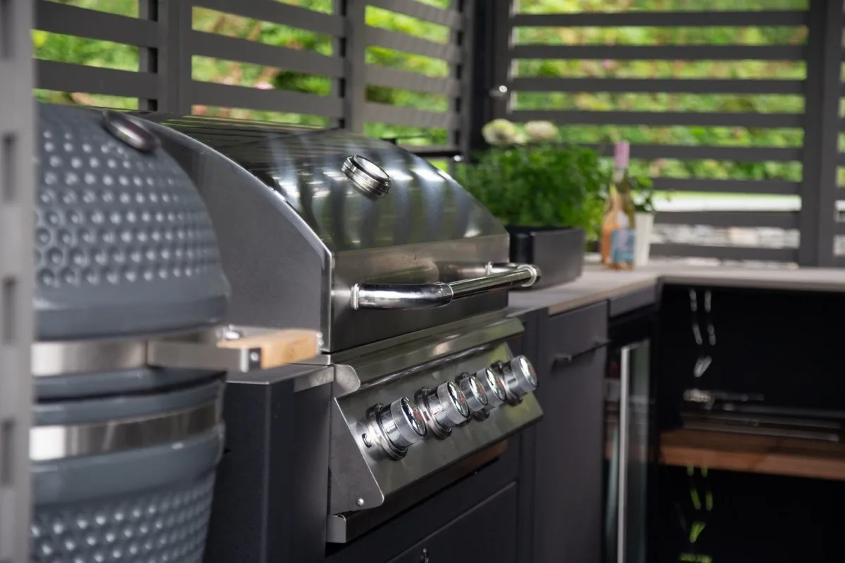 Stainless gas grill and ceramic kamado built into a bespoke Grillo outdoor kitchen in Surrey