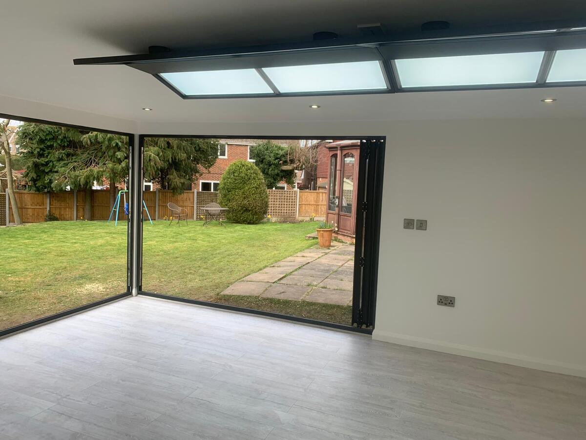 Garden studio interior with bifold doors and roof lights in Surrey